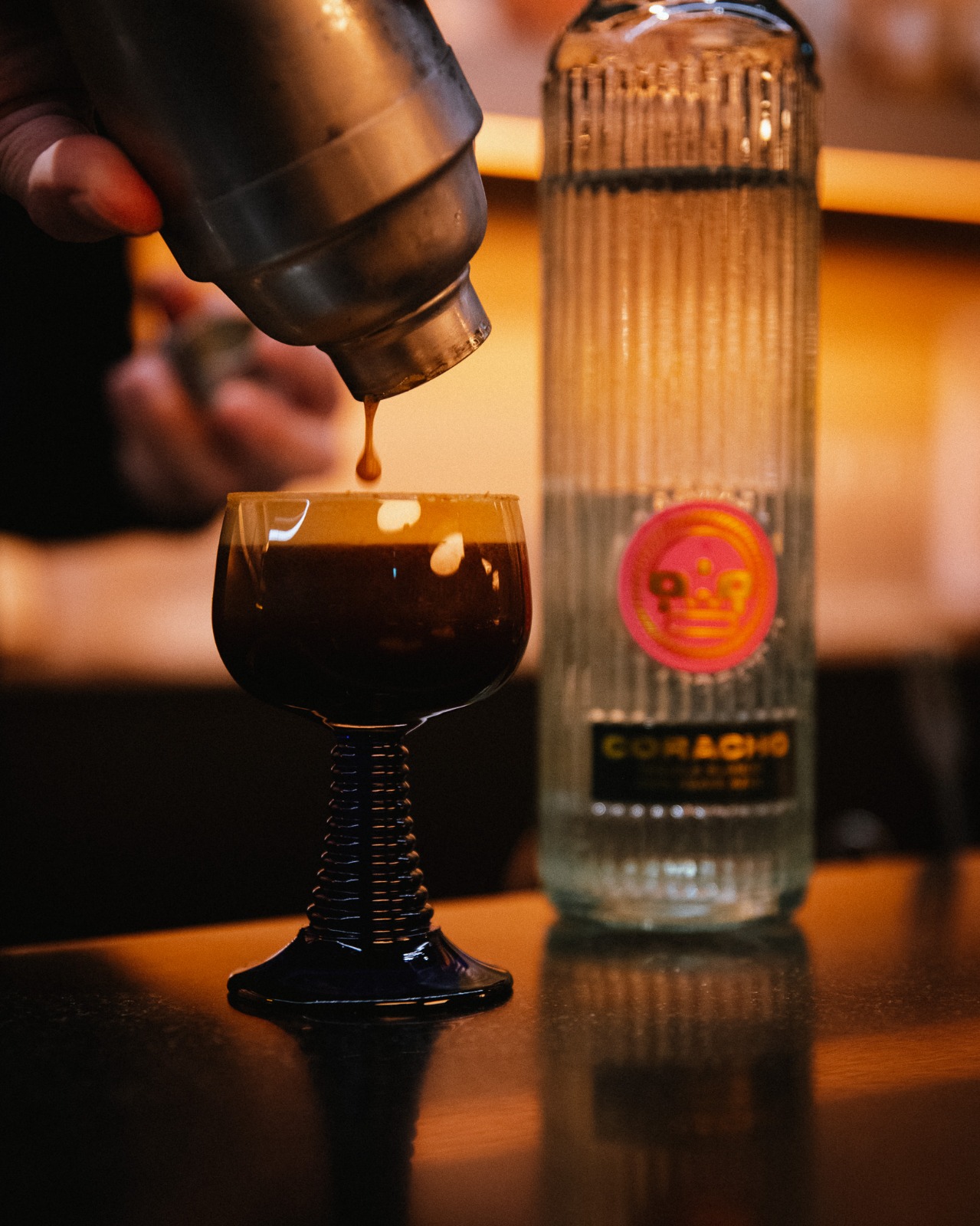 Bartender pouring a handcrafted cocktail with Coracho tequila at A Bunch Of Coffee