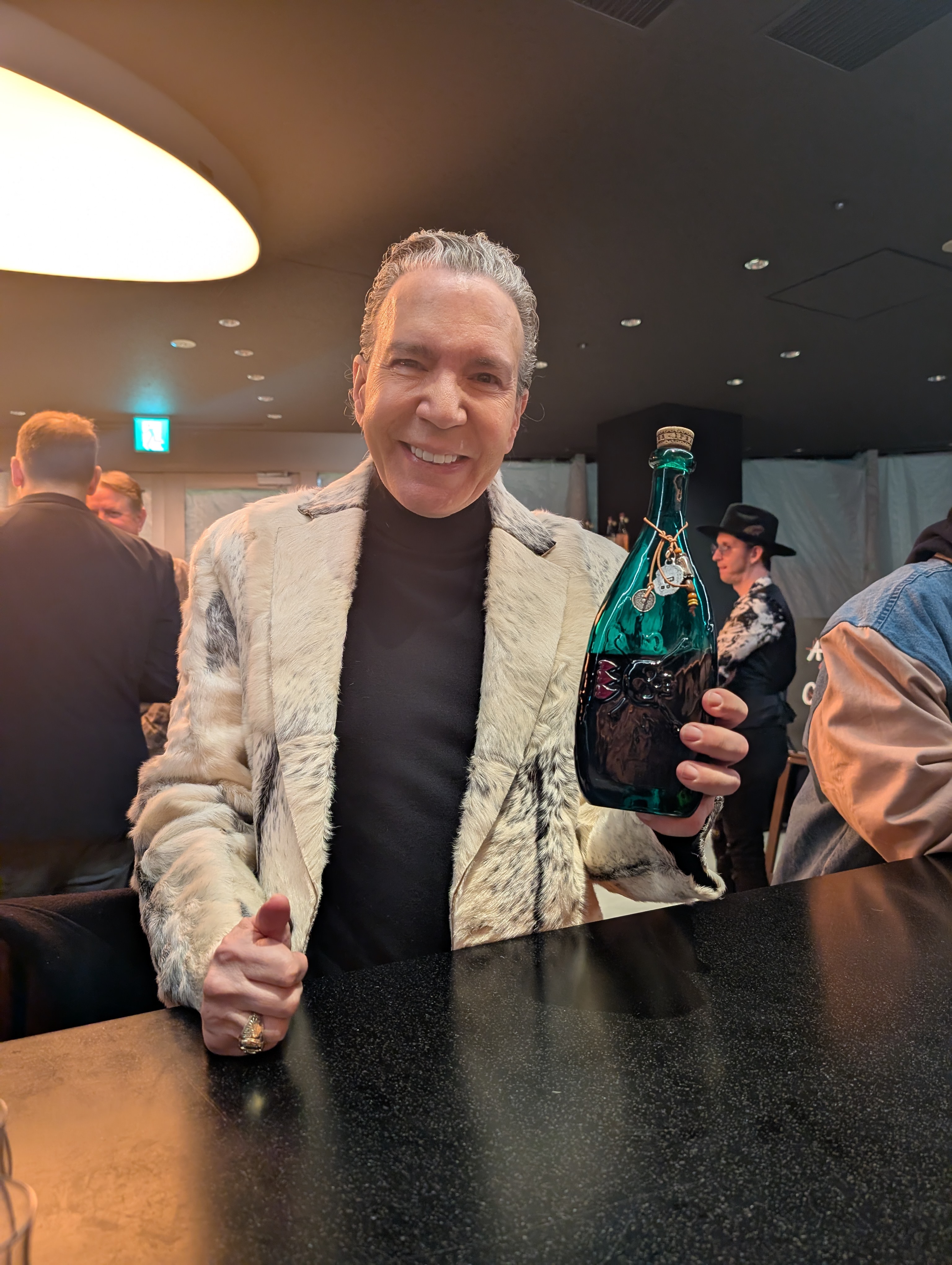 Stylish guest holding premium bottle at A Bunch Of Coffee bar