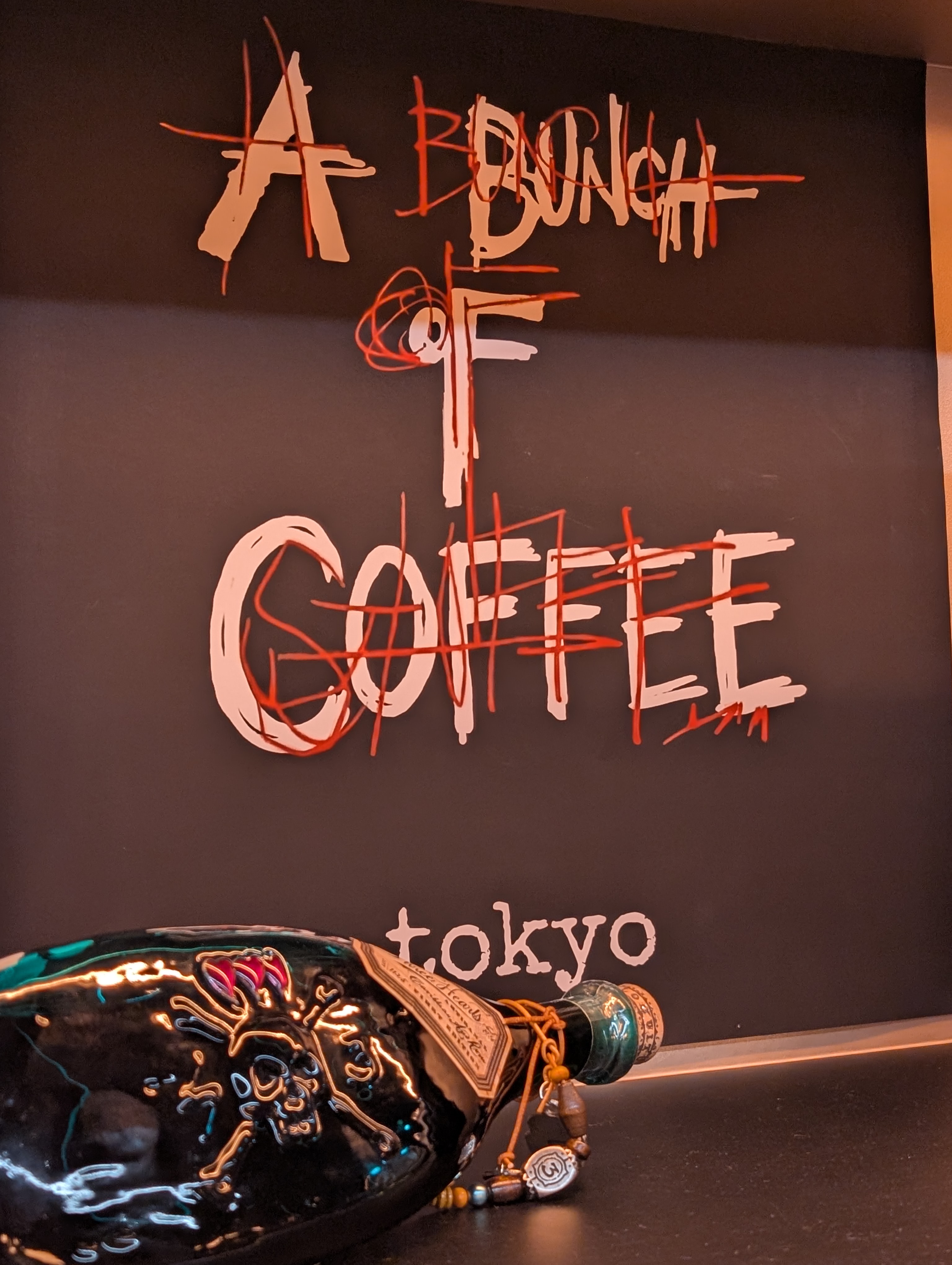 A Bunch Of Coffee Tokyo signature wall art with decorative bottle